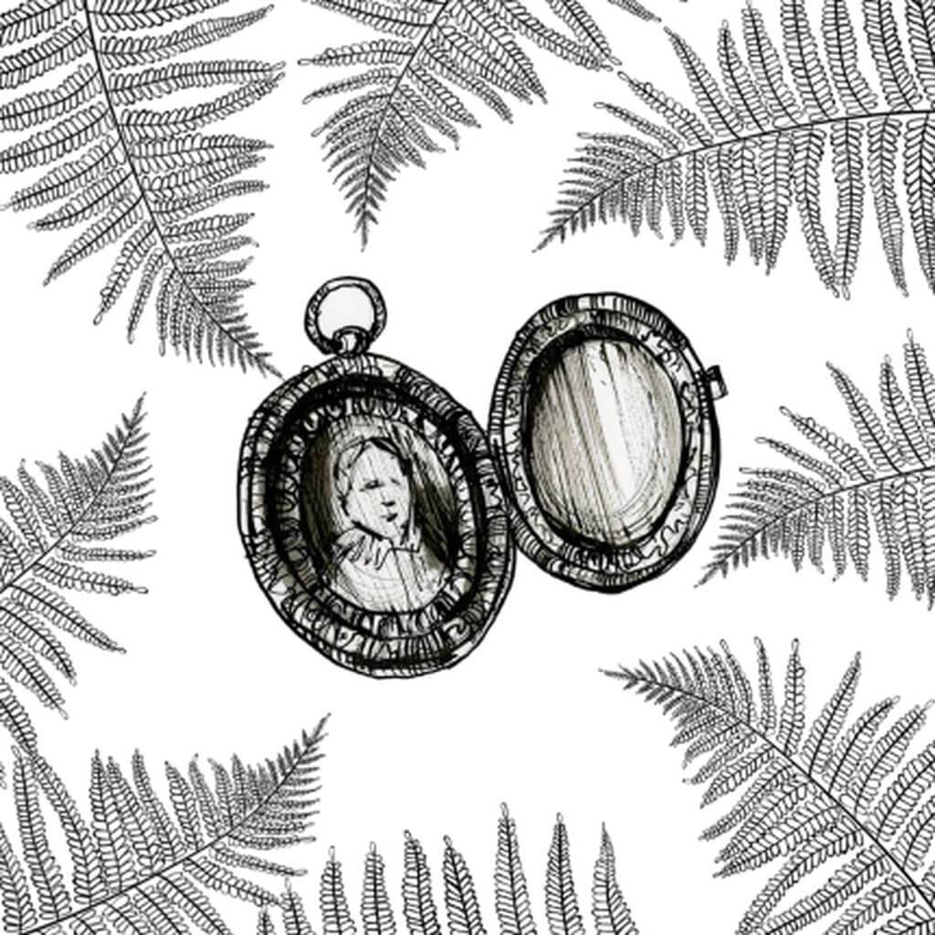 A tarnished silver locket, holding a portrait, resting on a bed of ferns