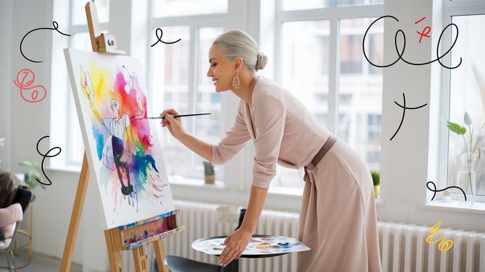 Mature woman painting with watercolors in a bright, modern studio