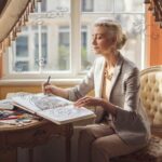 Woman engaged in meditative abstract pattern drawing by a sunny window