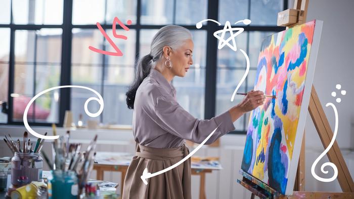 Woman creating colorful abstract wall art in a studio
