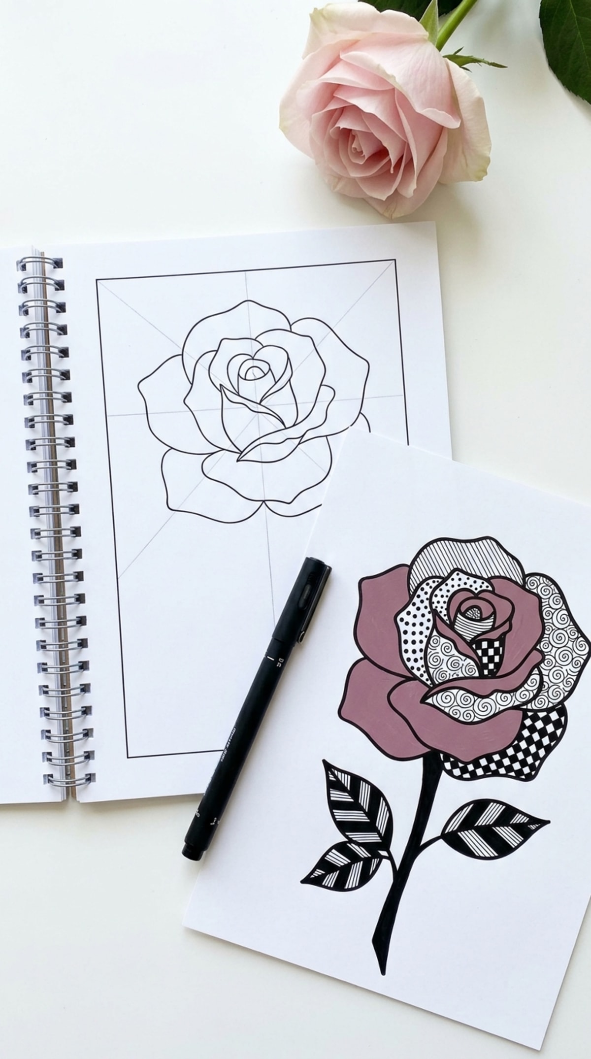 Open spiral-bound guide showing a rose template and a completed rose
