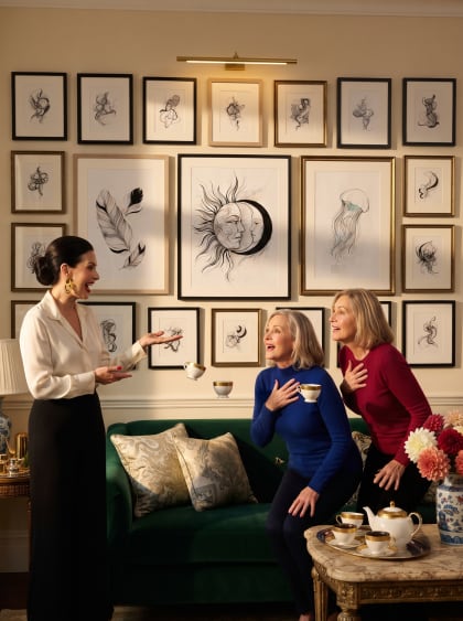 A jewel drawing room — the hostess presents her wall, two friends gasp over coffee