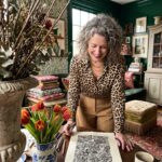 Woman looking at a finished zen doodle pattern panel on her table