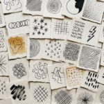 Abstract drawing ideas: about 40 torn paper squares, each carrying a different pen mark study