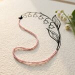 Art nouveau drawing cover: a silk thread curve turning into an ink lily of the valley