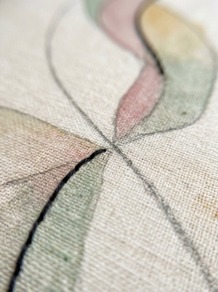 Hand embroidery patterns for beginners in close-up: a traced pencil line and the same line worked in thread, crossing on linen