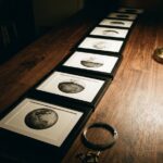 Moon phases drawing wall set: small framed ink moons in a row on a walnut table under low lamplight