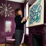 Neurographic art for beginners: a finished drawing of one wandering line with rounded crossings, propped on a mantel and filled with blue and teal