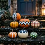 Pumpkin painting ideas for adults: uncarved pumpkins with bold painted patterns on stone steps at dusk