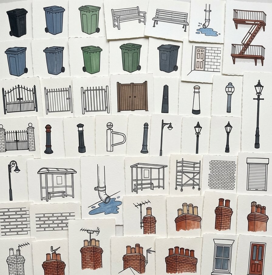 Dozens of small torn paper studies of street objects laid out edge to edge