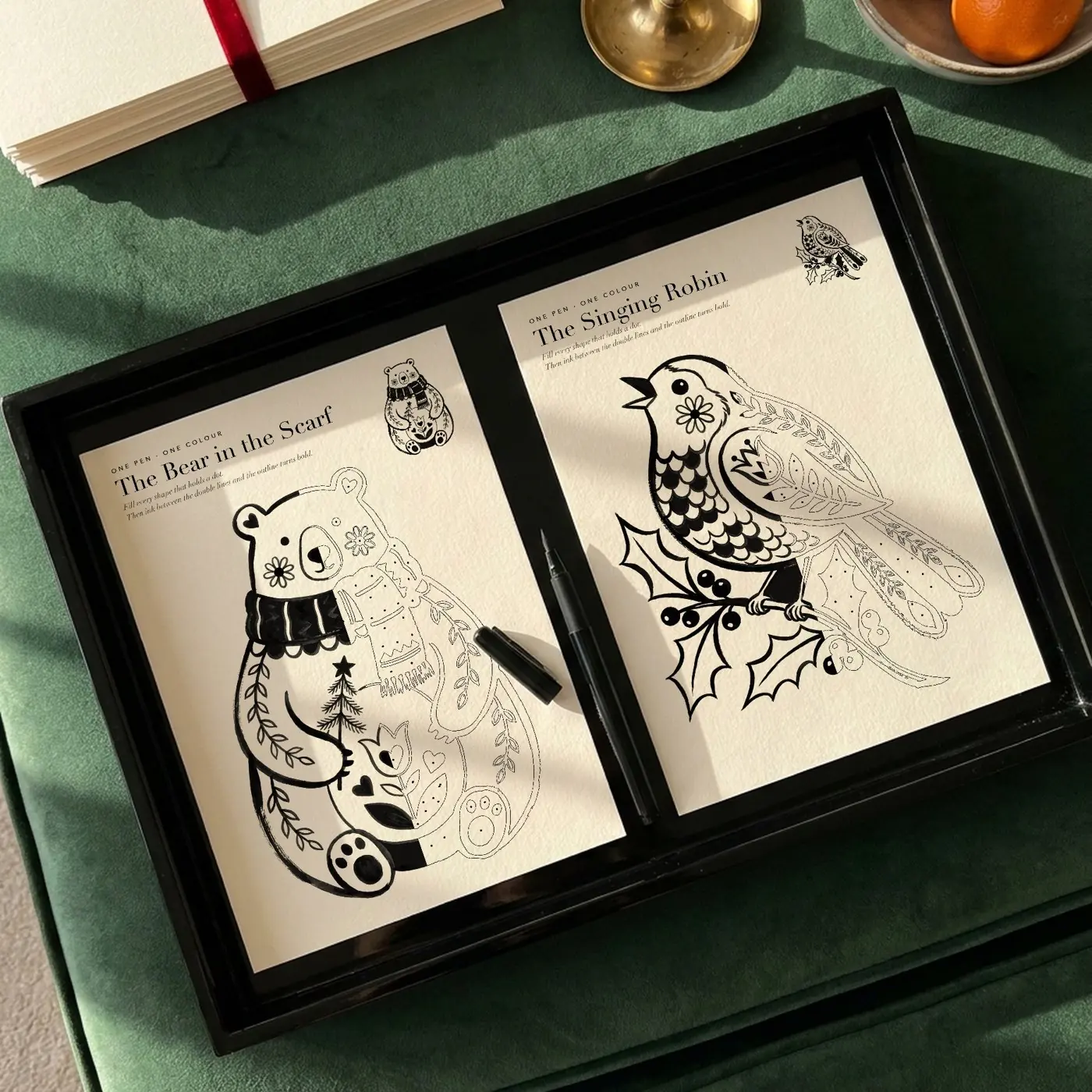 The Bear in the Scarf and the Singing Robin, half inked with one black pen on a lacquer tray